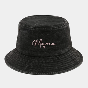 Detail of black washed denim bucket hat featuring pink Mama heart embroidery and brass eyelets