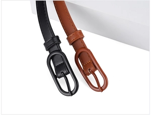 Detailed close-up of black and brown macaron colored belts with oval buckles for women