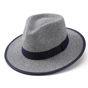 Detail of grey felt cowboy hat featuring navy blue ribbon trim and matching brim piping