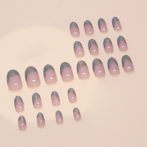 Press-on nails featuring nude pink base and silver glitter French V-shape design tips