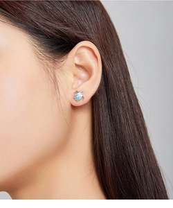 Close-up of cute blue sea turtle stud earring in silver finish worn on ear