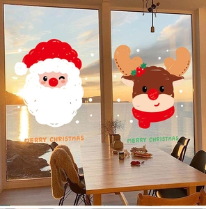 Cozy window view of Merry Christmas window clings featuring Santa and reindeer on glass