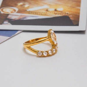 Detailed close-up of golden stainless steel ring featuring marquise-cut white zircon