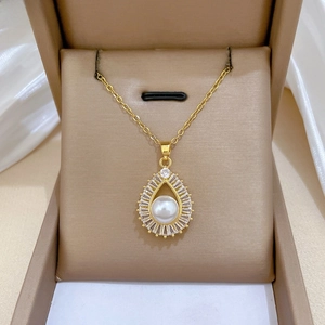 Macro detail of luxury teardrop pearl pendant with square zircons in jewelry box