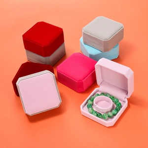 Close-up of colorful velvet octagonal jewelry boxes showcasing soft texture and bracelet storage