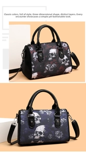 Close-up of gothic skull floral print boston bags with leather handles and metal hardware