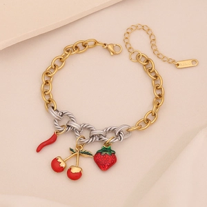 Detailed view of gold stainless steel bracelet with strawberry and cherry enamel charms