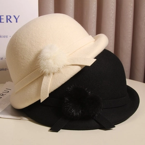 Elegant wool felt cloche hats in cream and black with pompom and ribbon detail