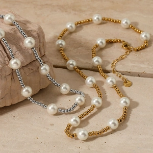 Elegant shell pearl beaded necklace in gold and silver finish on natural stone base
