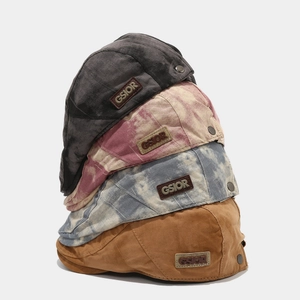 Stack of tie-dye and solid ivy caps with GSIOR leather patch and metal buttons
