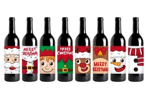 Detail of 8 different Christmas wine bottle labels with gold foil and festive patterns