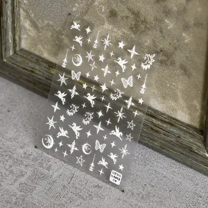 Detailed close-up of 5D white embossed nail stickers featuring stars, moon and Pegasus themes