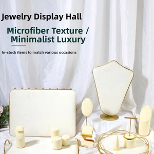 Velvet jewelry display set with gold metal frames on white textured background