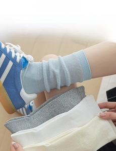 Detail of ribbed knit cotton crew socks in pastel blue, grey and cream white colors