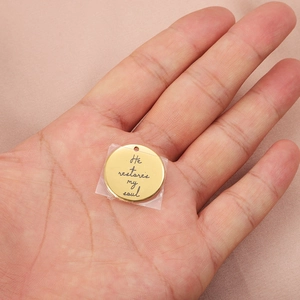 Handheld gold stainless steel round pendant with engraved He restores my soul text