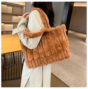 Macro detail of the brown plush tote bag showing vertical ribbed texture and soft fur