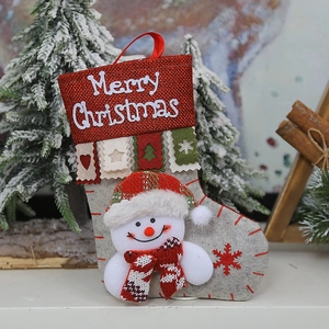 Close-up of Christmas stocking with snowman plush and Merry Christmas embroidery