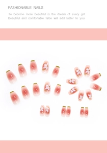 Detail of pink gradient press-on nails with white cherry blossoms and green French tips