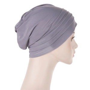Detail showing the layered pleated texture and fabric of the grey chemo headwear
