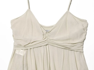 Detailed view of champagne V-neck satin camisole featuring elegant ruched pleats
