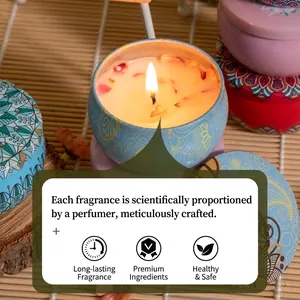 Scented tin candle with dried flower petals and ethnic patterns on a bamboo background