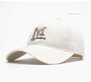 Close-up of beige baseball cap with 3D embroidery showing detail of M CIAMPAL lettering