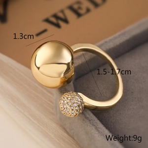 Detailed close-up of 18K gold-plated irregular ring with two-ball design and zircons
