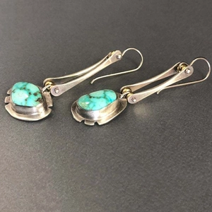 Asymmetric geometric turquoise earrings with vintage silver metal in a long drop style