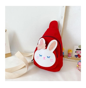 Detail of red rabbit chest bag for kids with white leather bunny patch and shiny pink bow