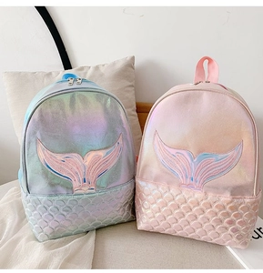 Close-up of holographic mermaid tail embroidery and fish scale texture on backpacks