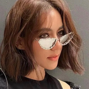 Luxury cat eye sunglasses with diamond frame and silver metal temples on model