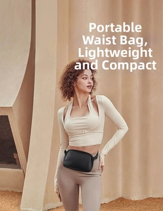 Detail of a black waterproof nylon belt bag worn by a model in a minimalist setting