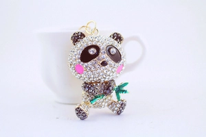 Macro shot of sparkling rhinestone panda keychain with green bamboo detail