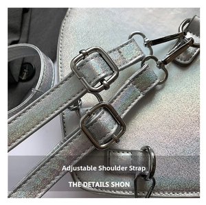 Detail of laser heart shoulder bag featuring adjustable silver metal buckle straps