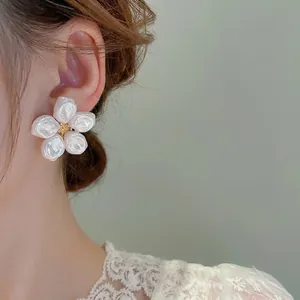 Orecchini a fiore con perle barocche e centro in zircone dorato in stile minimal