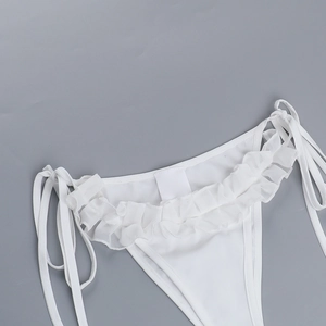 Detail of white bikini bottoms featuring ruffled edges and adjustable side tie closures
