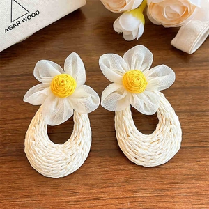 Handwoven floral drop earrings with white chiffon petals and raffia texture for summer