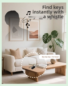 Wireless key finder with ring attached to keys in a modern home living room setting