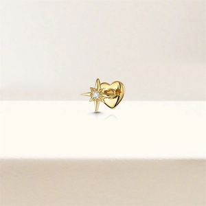 Macro shot of 925 sterling silver gold heart earring with a crystal-set star center