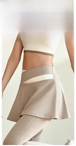 Macro detail of the crossover high waist design and elastic beige athletic skort fabric