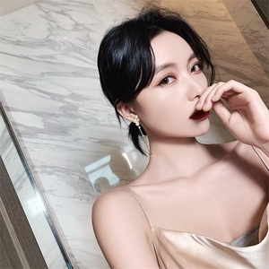 Elegant long pearl tassel drop earrings for women featured on a model with silk dress