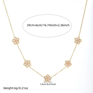 Detail showing dimensions of the gold necklace with white flower pendants on white background