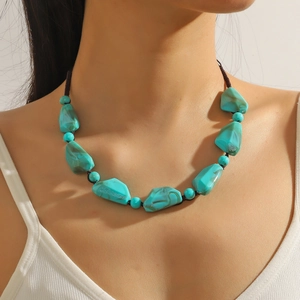 Detail of turquoise bead necklace with bohemian style stones on brown braided cord