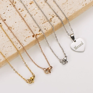 Three-color heart necklaces in gold, rose gold and silver with Blessed engraving