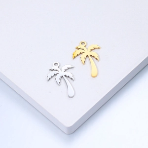 Detailed view of gold and silver palm tree charms for DIY jewelry on a white pedestal