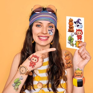 Close-up of Halloween temporary tattoos featuring pumpkins, ghosts, and zombies on skin