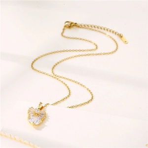 Elegant gold bow necklace with sparkling zircon pendant on minimalist link chain