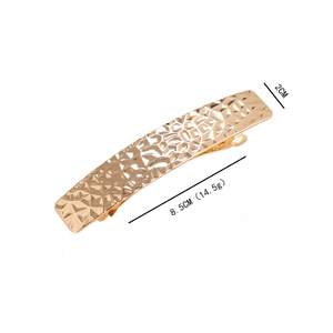 Minimalist gold metal hair clip with geometric hammer texture and dimensions 8.5cm by 2cm