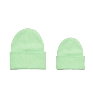 Matching parent-child mint green knit beanies in ribbed style on white background