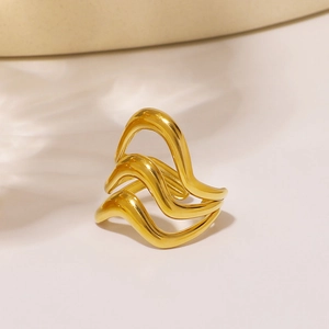 Polished 18K gold plated stainless steel multi-layer wavy ring on a neutral background